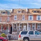 a front view of a building with parking space