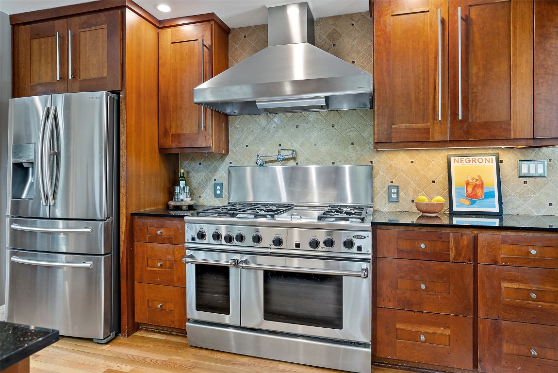 2208 Mountain View Road Austin, TX 78703 - Photo 12 of 39 a kitchen with stainless steel appliances granite countertop a stove and a refrigerator