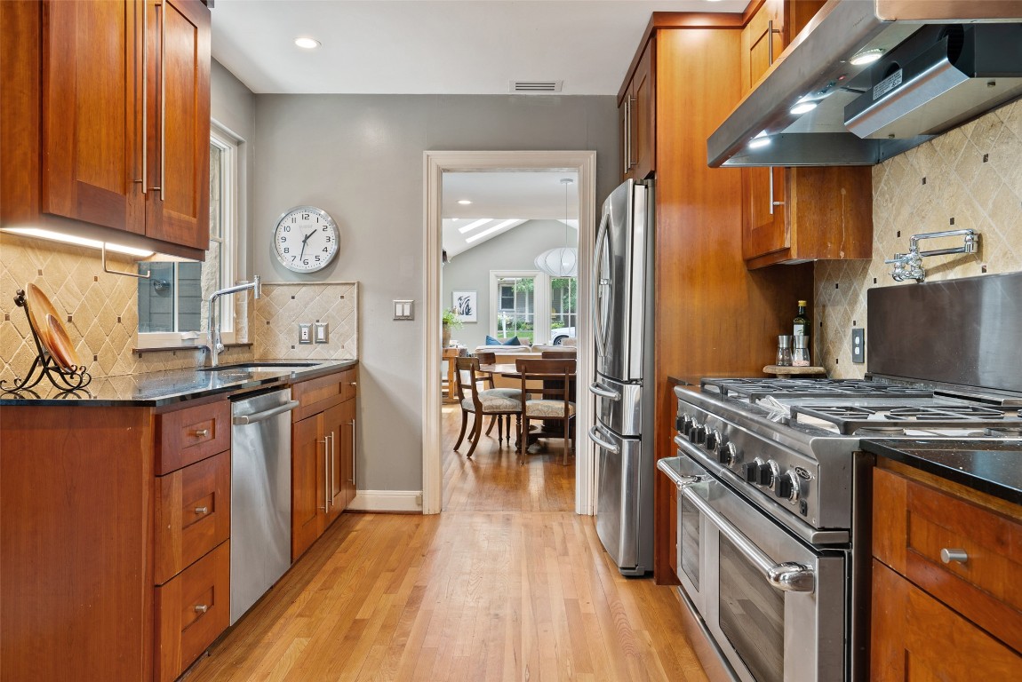 2208 Mountain View Road Austin, TX 78703 - Photo 13 of 39 a kitchen with stainless steel appliances granite countertop a stove and a refrigerator
