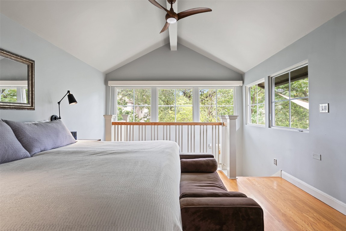 2208 Mountain View Road Austin, TX 78703 - Photo 22 of 39 a bedroom with a large bed and a window
