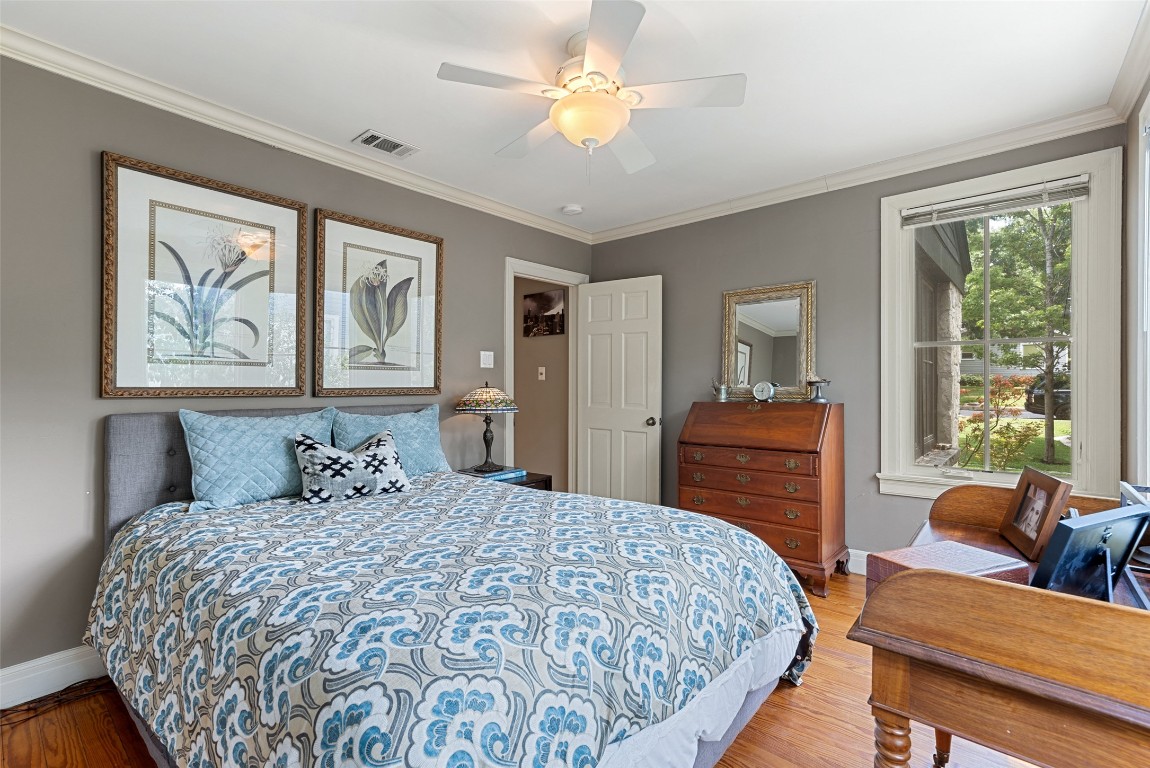 2208 Mountain View Road Austin, TX 78703 - Photo 28 of 39 a bedroom with a bed and wooden floor