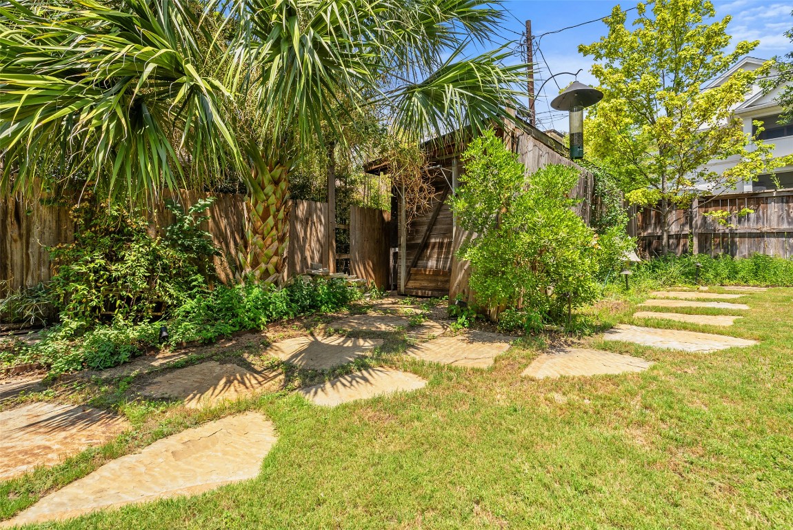 2208 Mountain View Road Austin, TX 78703 - Photo 35 of 39 a backyard of a house with lots of green space and fountain