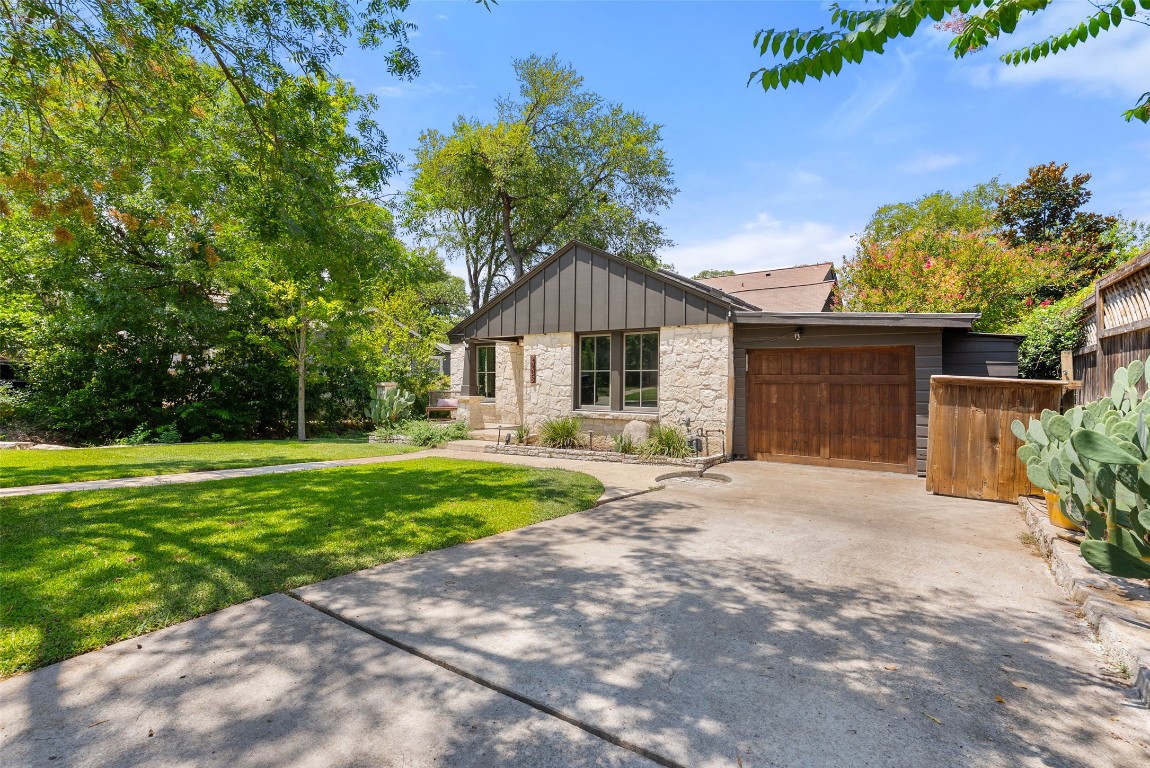 2208 Mountain View Road Austin, TX 78703 - Photo 38 of 39 a front view of a house with a yard and garage