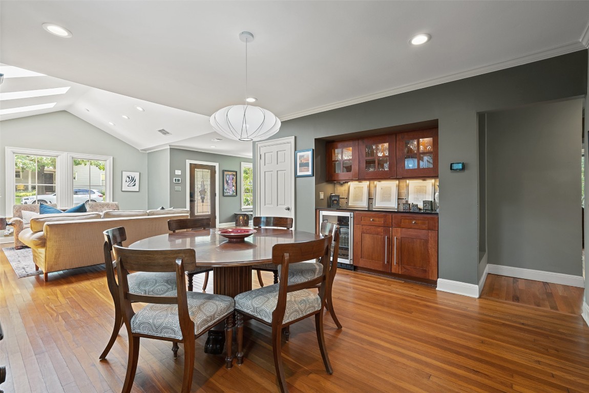 2208 Mountain View Road Austin, TX 78703 - Photo 9 of 39 a dining room with wooden floor a chandelier a wooden table and chairs