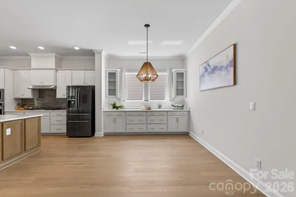 a kitchen with stainless steel appliances a refrigerator sink and microwave