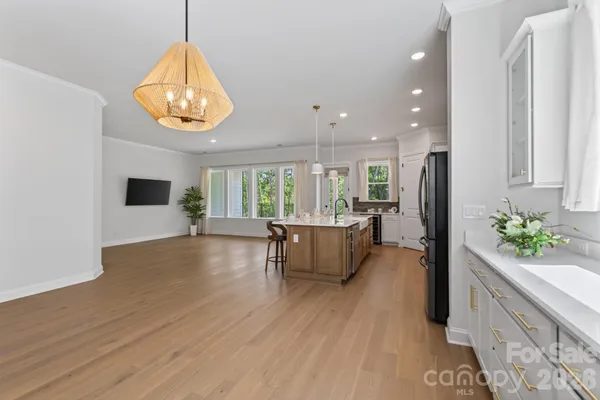 an open kitchen with kitchen island and stainless steel appliances