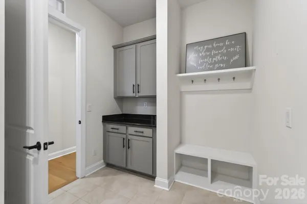 a kitchen with white cabinets and white appliances