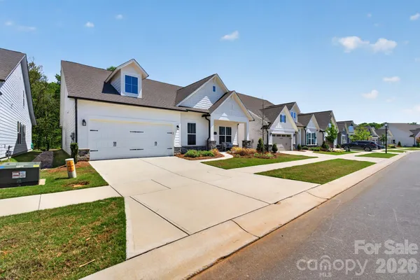 a view of an house with backyard space and yard