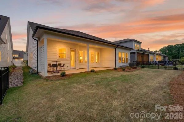 a view of a house with backyard and porch
