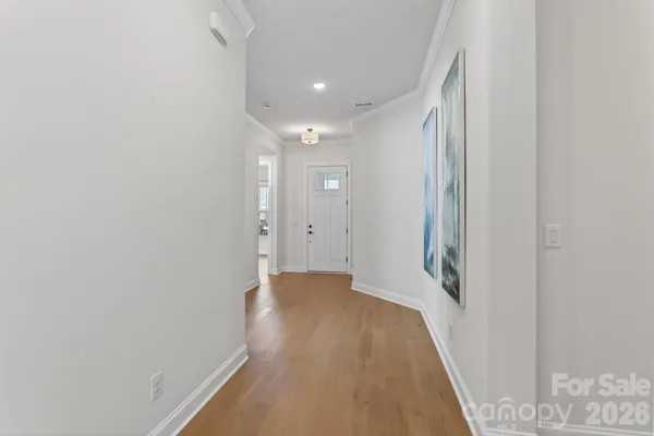 a view of a hallway with wooden floor