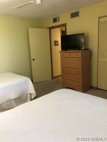 a bedroom with a bed and flat screen tv