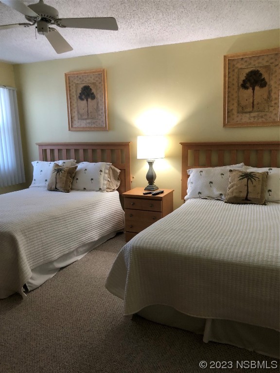 4745 South Atlantic Avenue, Unit 4030 Ponce Inlet, FL 32127 - Photo 17 of 47 a bedroom with two beds and painting on the wall