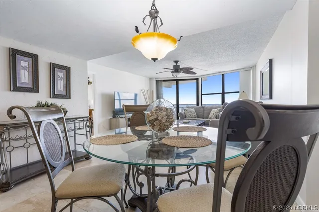 a view of a dining room with furniture and chandelier