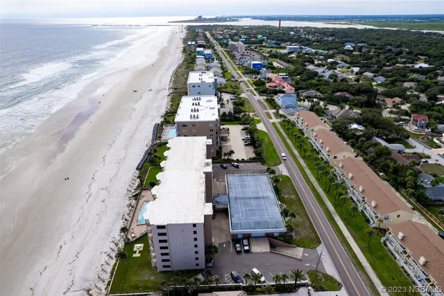 an aerial view of residential houses with outdoor space