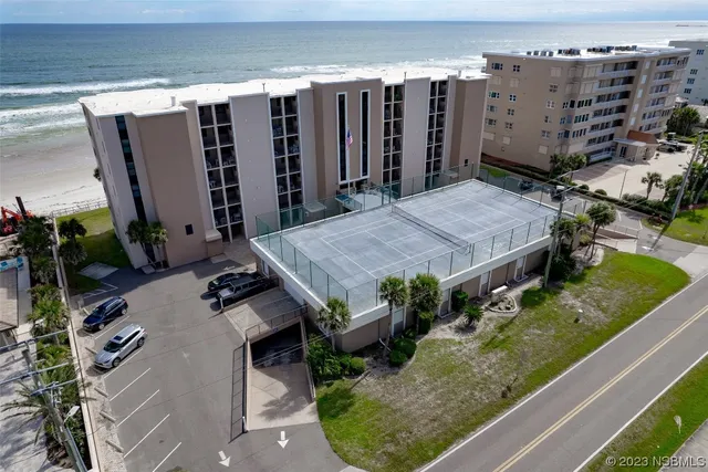an aerial view of a house with garden space and street view