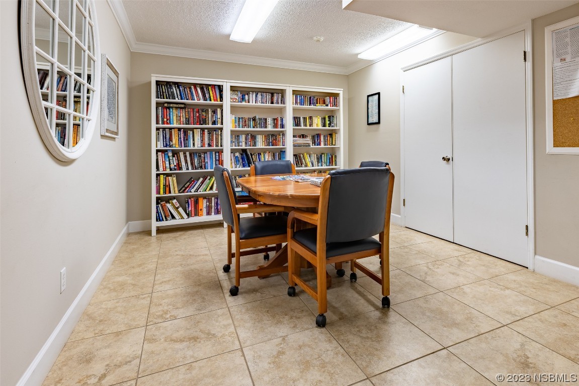 4745 South Atlantic Avenue, Unit 4030 Ponce Inlet, FL 32127 - Photo 37 of 47 a view of a workspace with furniture and a bookshelf