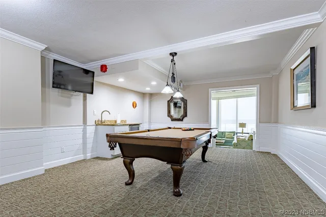 a view of a room with a table and chairs