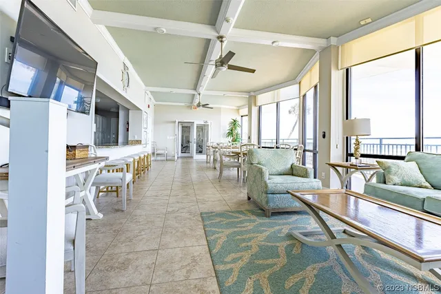 a living room with lots of furniture and a large window