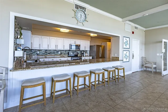 a kitchen with table chairs sink and cabinets