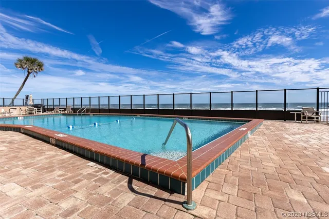 a view of swimming pool with seating area