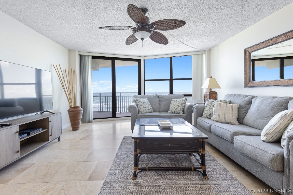 4745 South Atlantic Avenue, Unit 4030 Ponce Inlet, FL 32127 - Photo 5 of 47 a living room with furniture and a fireplace