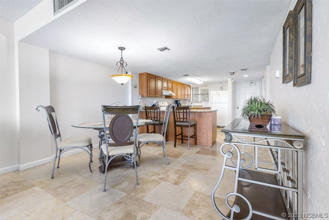 4745 South Atlantic Avenue, Unit 4030 Ponce Inlet, FL 32127 - Photo 7 of 47 a view of a dining room with furniture