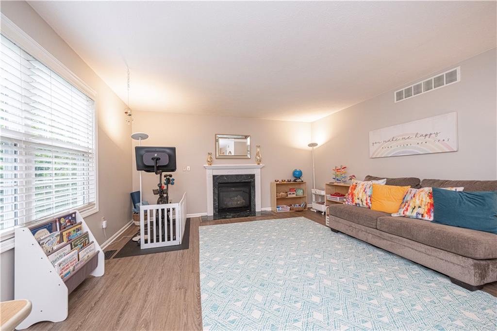 435 Cottage Lane Monroeville, PA 15146 - Photo 12 of 46 Cozy family room with a gas fireplace, seamlessly connected to the kitchen—perfect for relaxing or entertaining