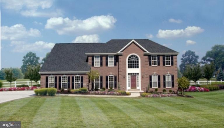 204 Manning Road East Accokeek, MD 20607 - Photo 1 of 1 a front view of a house with a garden and yard