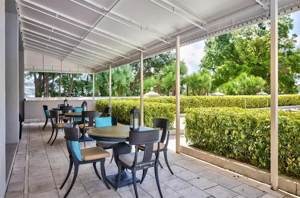 a view of an outdoor dining space with furniture and garden view