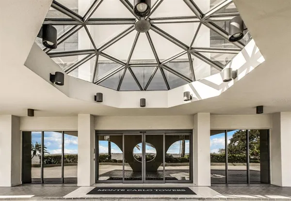 an empty room with wooden floor a table and chairs