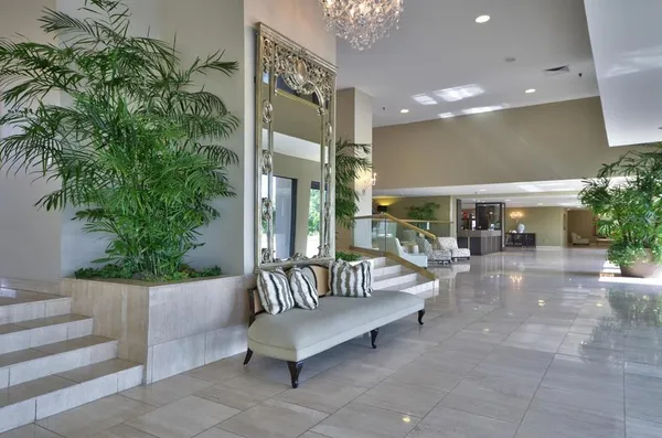 a view of a patio with couches table and chairs and potted plants
