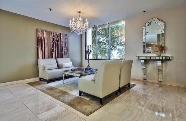 a living room with furniture and a chandelier