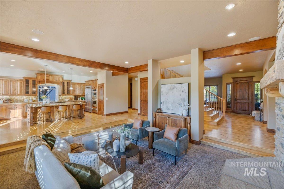 1479 West Oakhampton Drive Eagle, ID 83616 - Photo 17 of 49 Living area with beamed ceiling, stairs, recessed lighting, and light wood finished floors