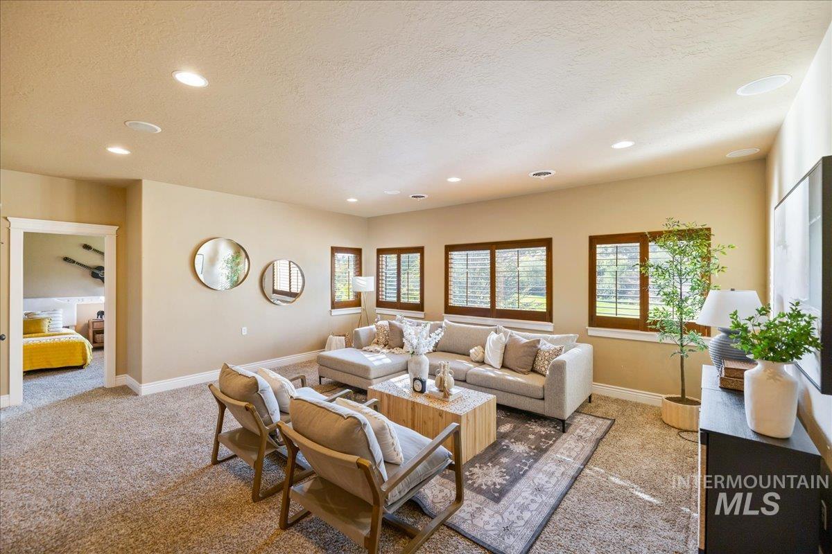 1479 West Oakhampton Drive Eagle, ID 83616 - Photo 21 of 49 Living area featuring carpet floors, a textured ceiling, and recessed lighting