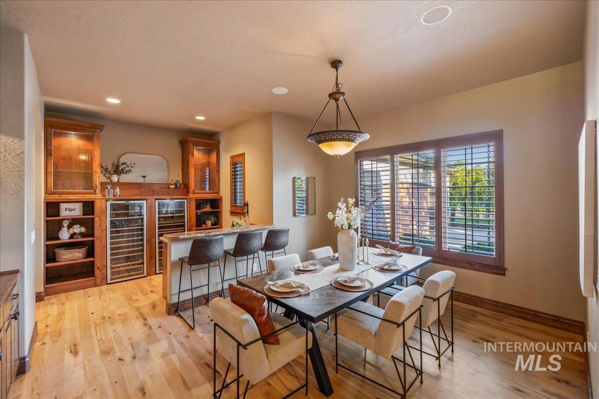 1479 West Oakhampton Drive Eagle, ID 83616 - Photo 22 of 49 Dining area featuring wine cooler, recessed lighting, and light wood-type flooring