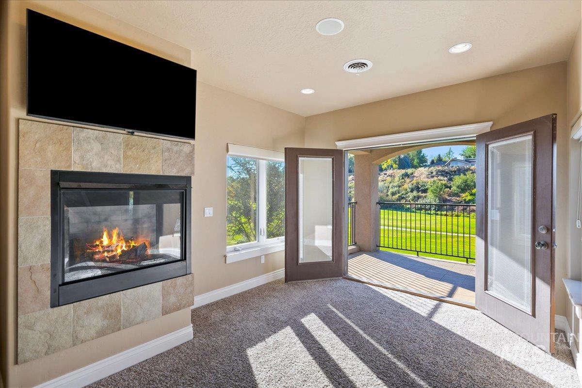 1479 West Oakhampton Drive Eagle, ID 83616 - Photo 27 of 49 Doorway featuring carpet, a tile fireplace, recessed lighting, and french doors