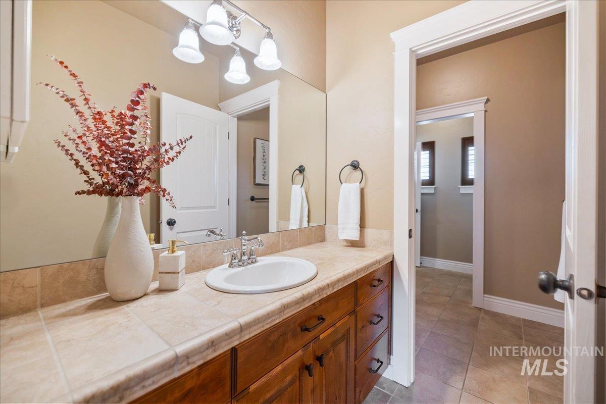 1479 West Oakhampton Drive Eagle, ID 83616 - Photo 36 of 49 Bathroom with vanity and light tile patterned floors
