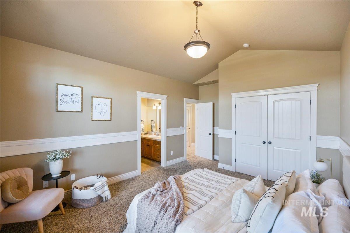 1479 West Oakhampton Drive Eagle, ID 83616 - Photo 37 of 49 Carpeted bedroom with vaulted ceiling, connected bathroom, and a closet