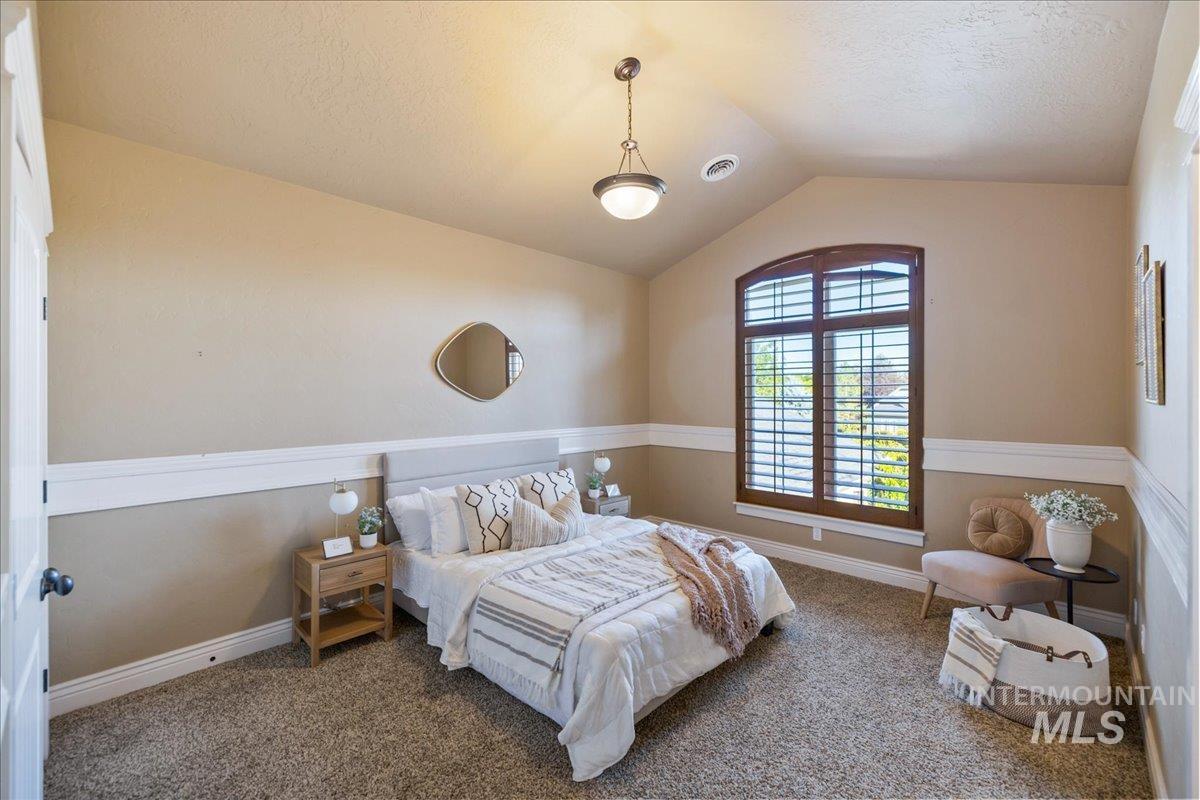 1479 West Oakhampton Drive Eagle, ID 83616 - Photo 38 of 49 Bedroom featuring vaulted ceiling, carpet, and a textured ceiling