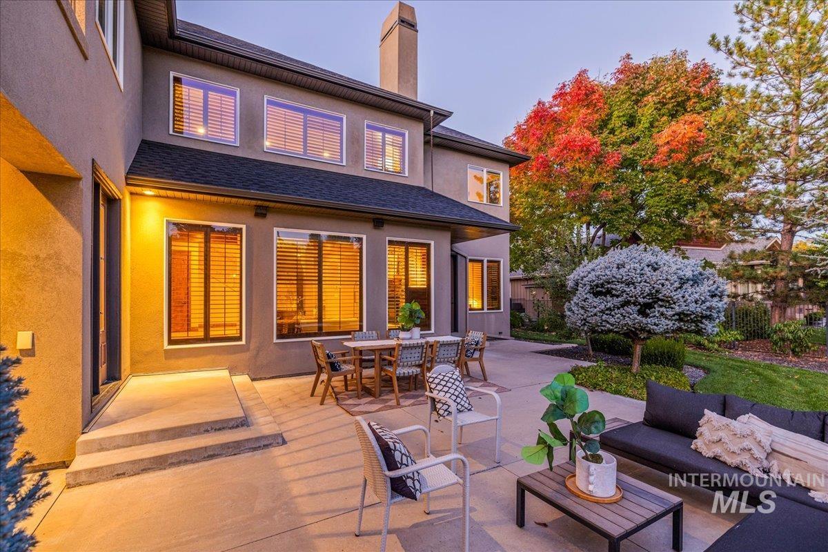 1479 West Oakhampton Drive Eagle, ID 83616 - Photo 44 of 49 Rear view of property featuring stucco siding, a patio, an outdoor hangout area, and a chimney