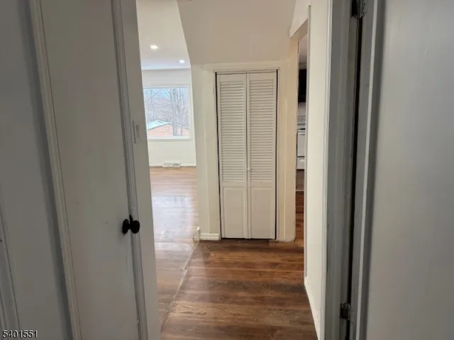 a view of a hallway with wooden floor