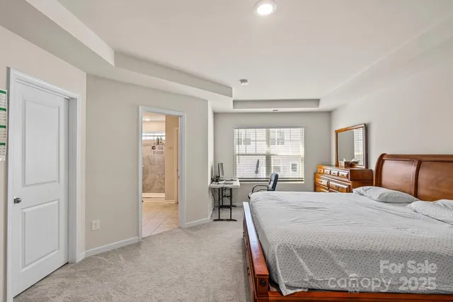 a bedroom with a bed and large windows