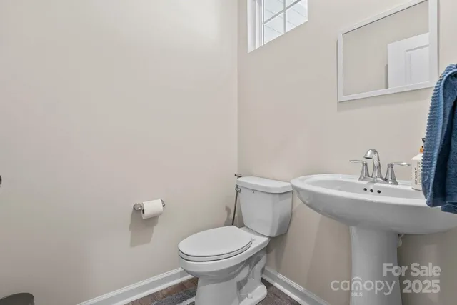 a bathroom with a sink a toilet and mirror