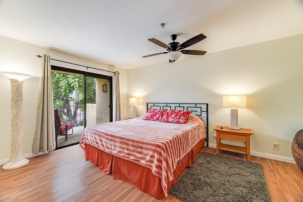 200 East Racquet Club Road, Unit 68 Palm Springs, CA 92262 - Photo 21 of 32 a bedroom with a bed a couch and a window