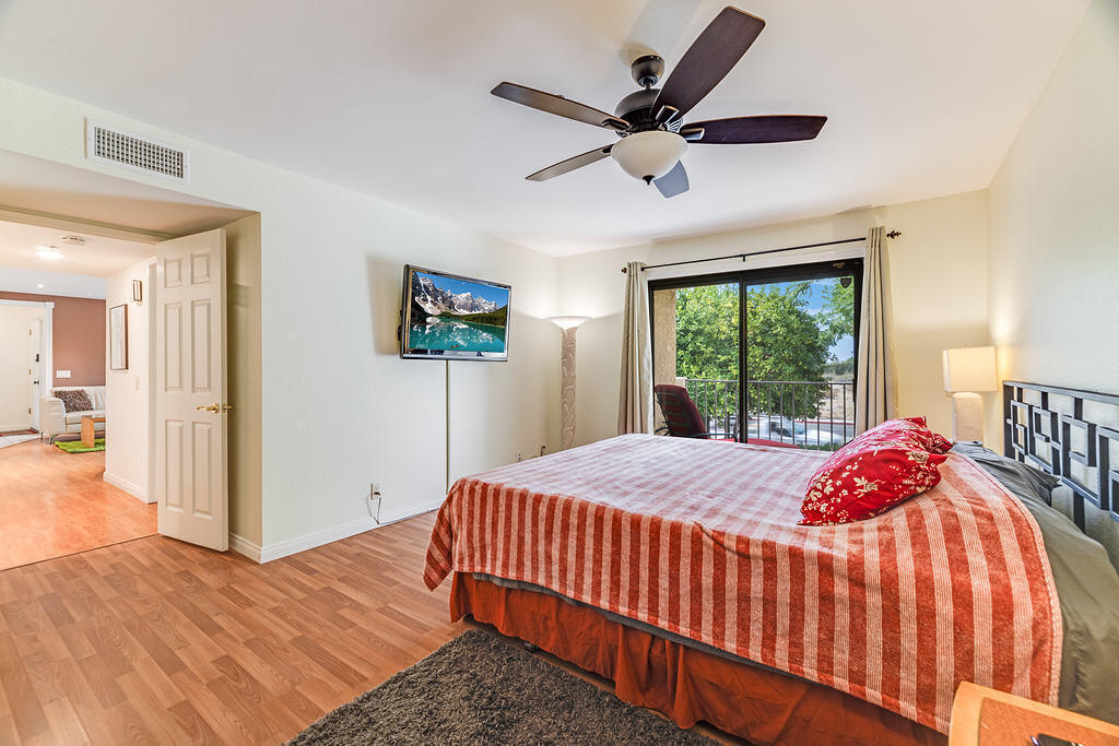 200 East Racquet Club Road, Unit 68 Palm Springs, CA 92262 - Photo 22 of 32 a bedroom with a bed and a window
