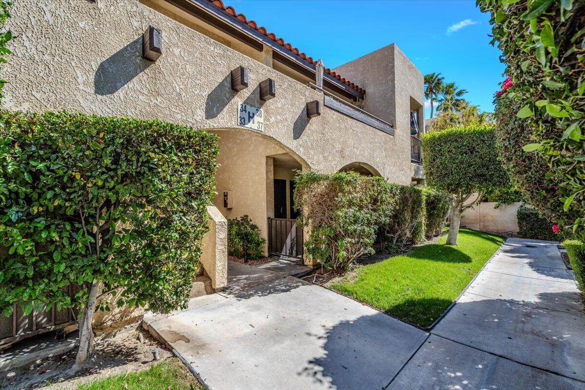 200 East Racquet Club Road, Unit 68 Palm Springs, CA 92262 - Photo 27 of 32 front view of a house with a yard
