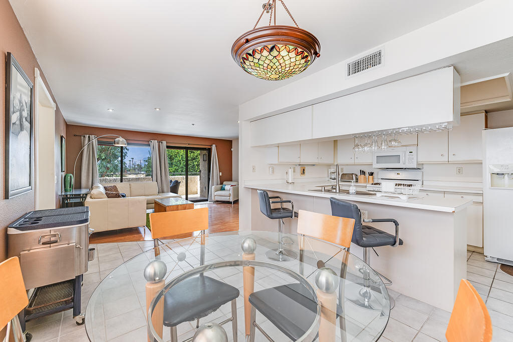 200 East Racquet Club Road, Unit 68 Palm Springs, CA 92262 - Photo 3 of 32 a large kitchen with a table and chairs