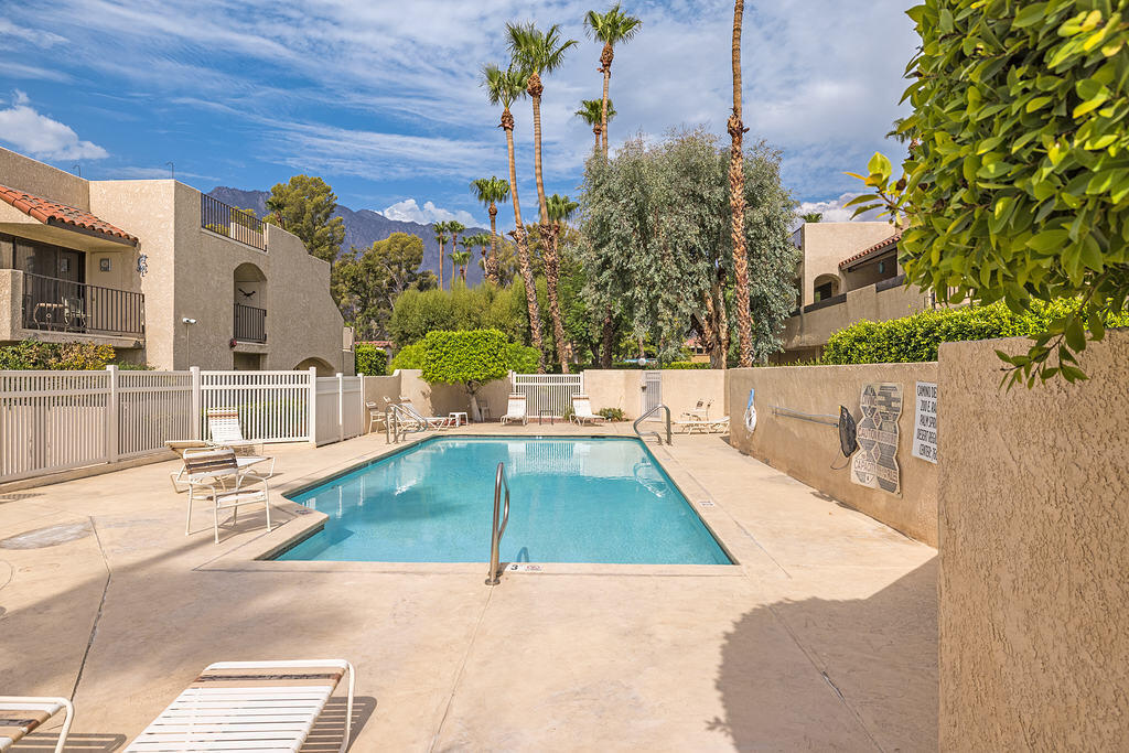 200 East Racquet Club Road, Unit 68 Palm Springs, CA 92262 - Photo 31 of 32 a view of a swimming pool with an outdoor seating