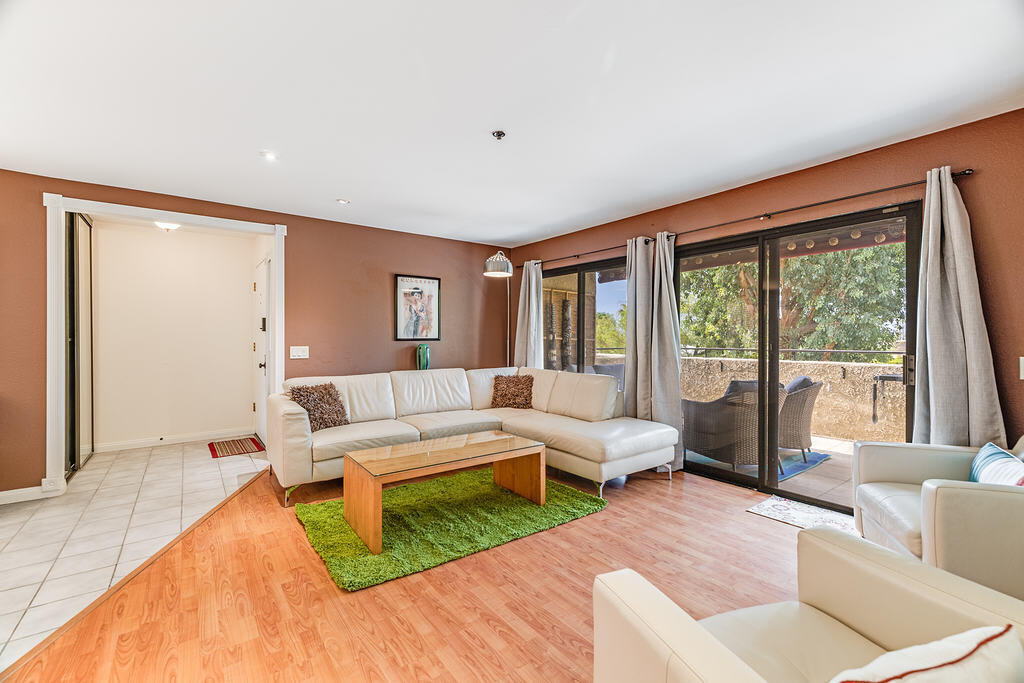 200 East Racquet Club Road, Unit 68 Palm Springs, CA 92262 - Photo 4 of 32 a living room with furniture and a large window