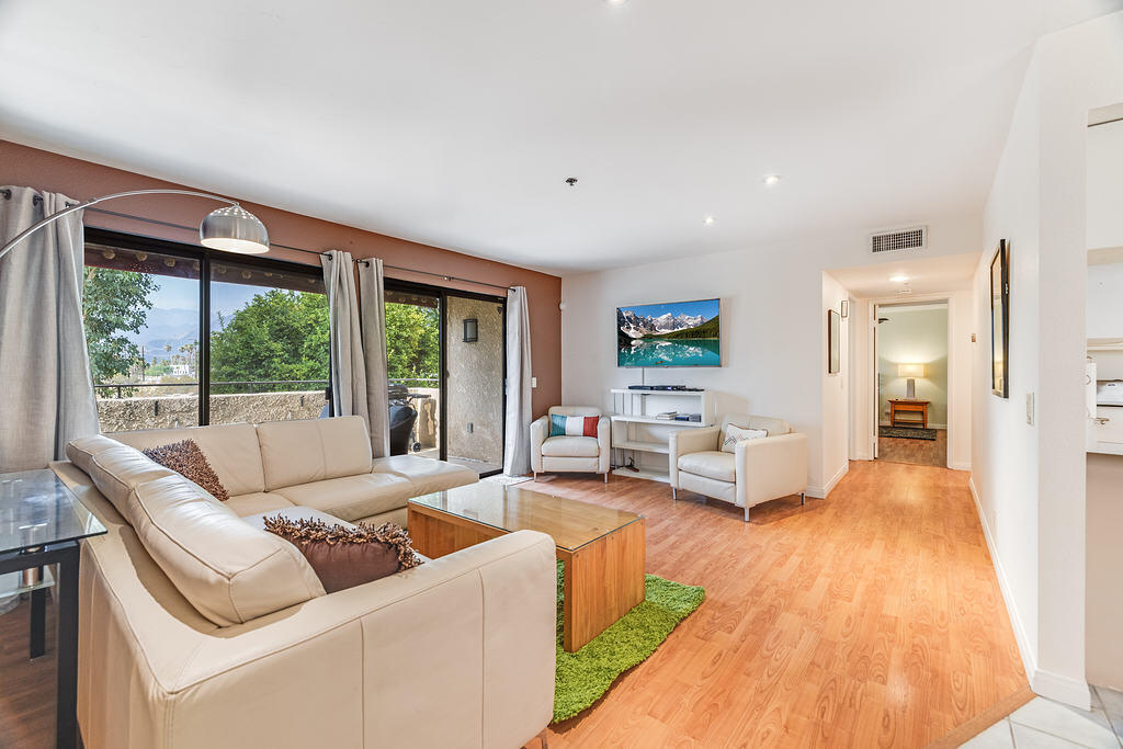 200 East Racquet Club Road, Unit 68 Palm Springs, CA 92262 - Photo 7 of 32 a living room with furniture and large windows